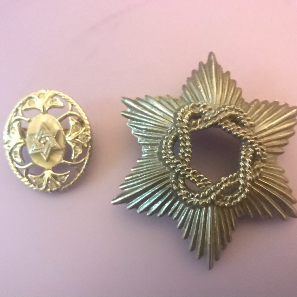 Two metal brooches